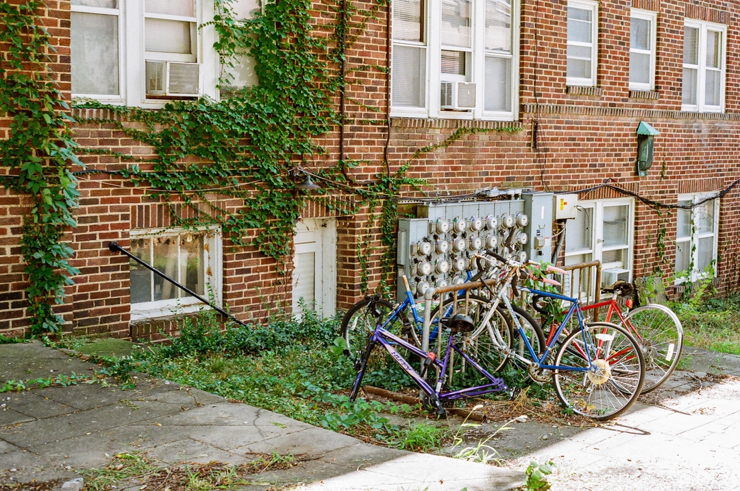Photo of broken down bikes on the side of a building in Columbia, MO (2019).